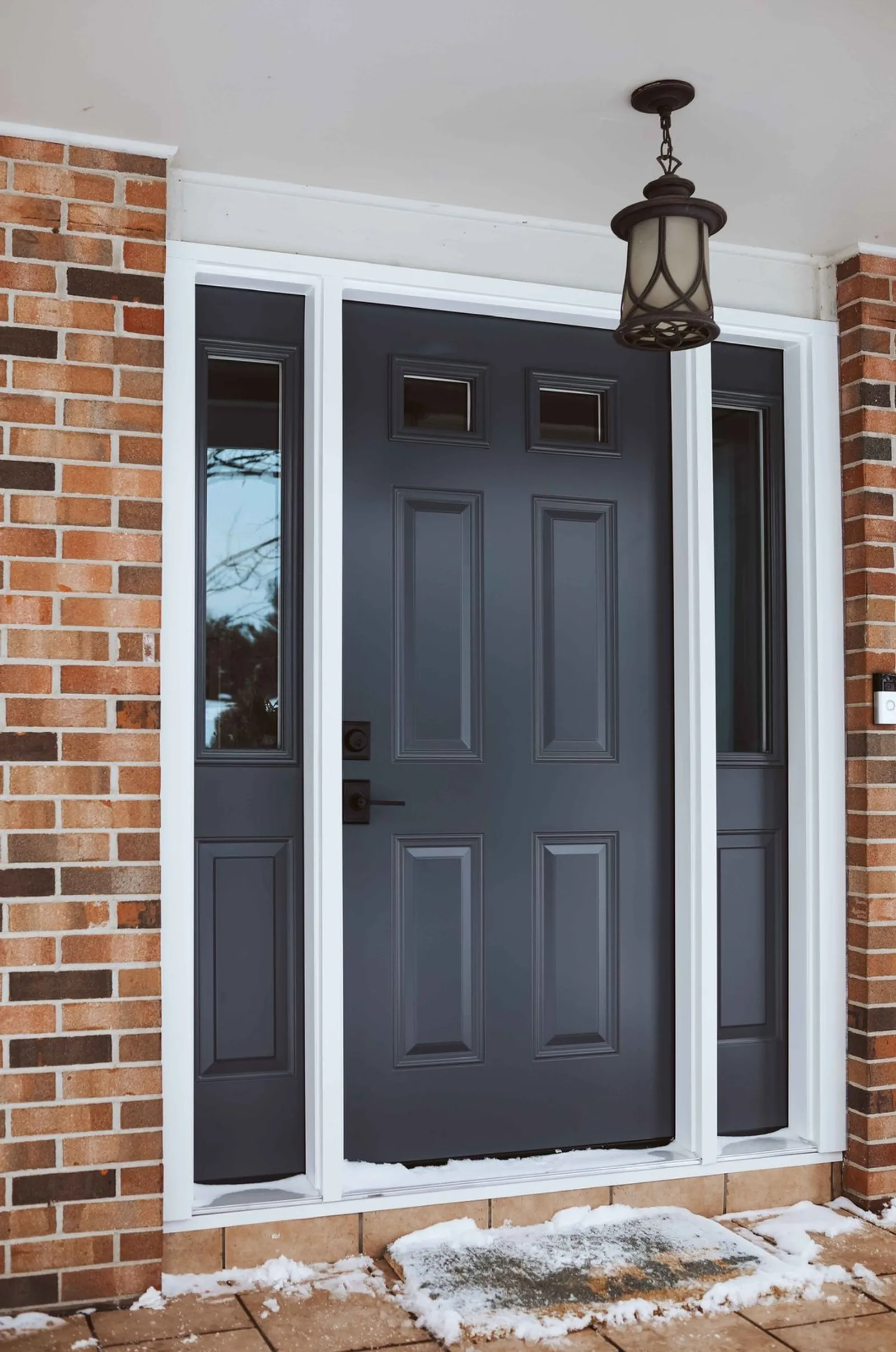 Charcoal entry door with full-height sidelights