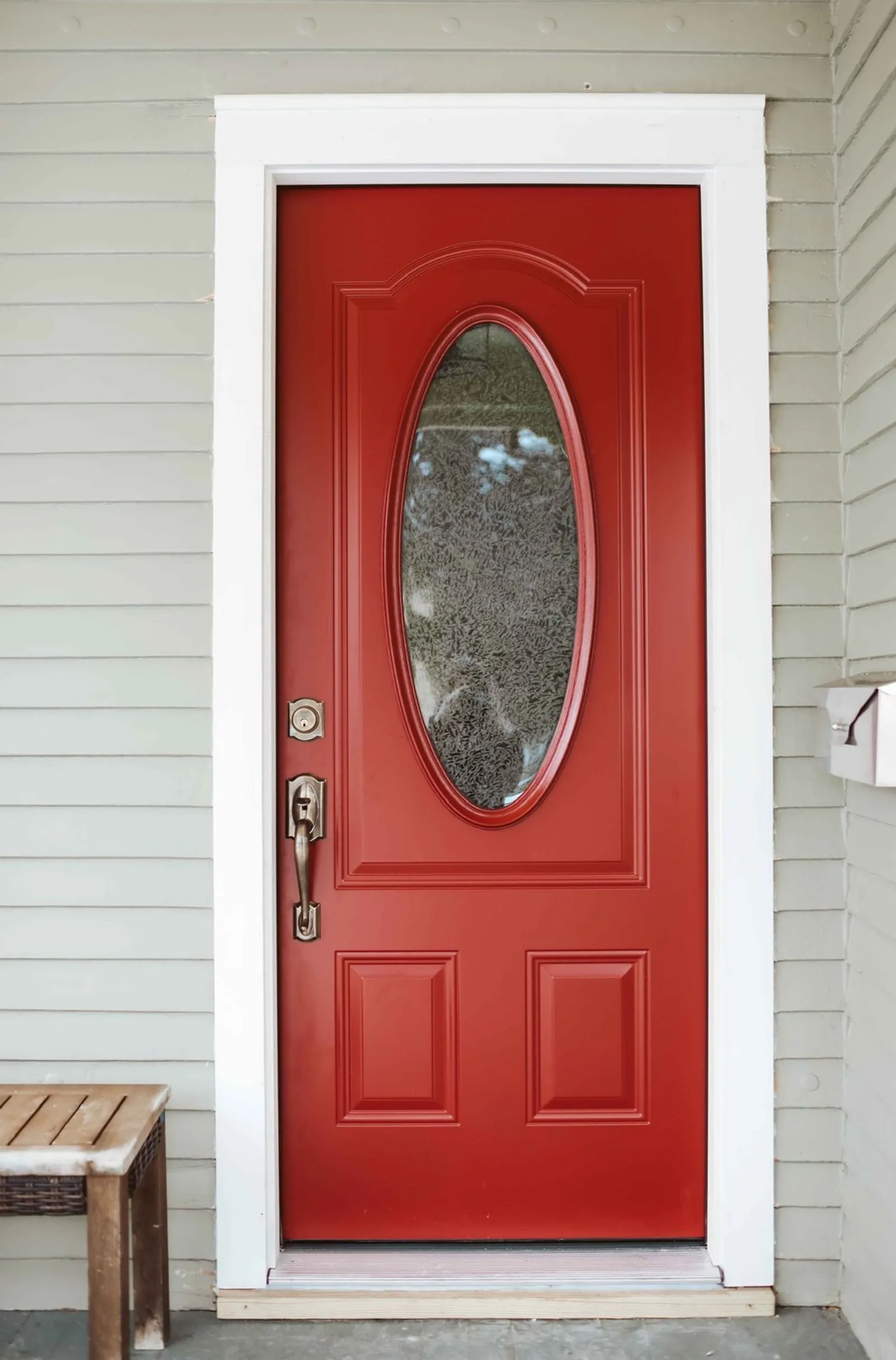 Red entry door with oval glass