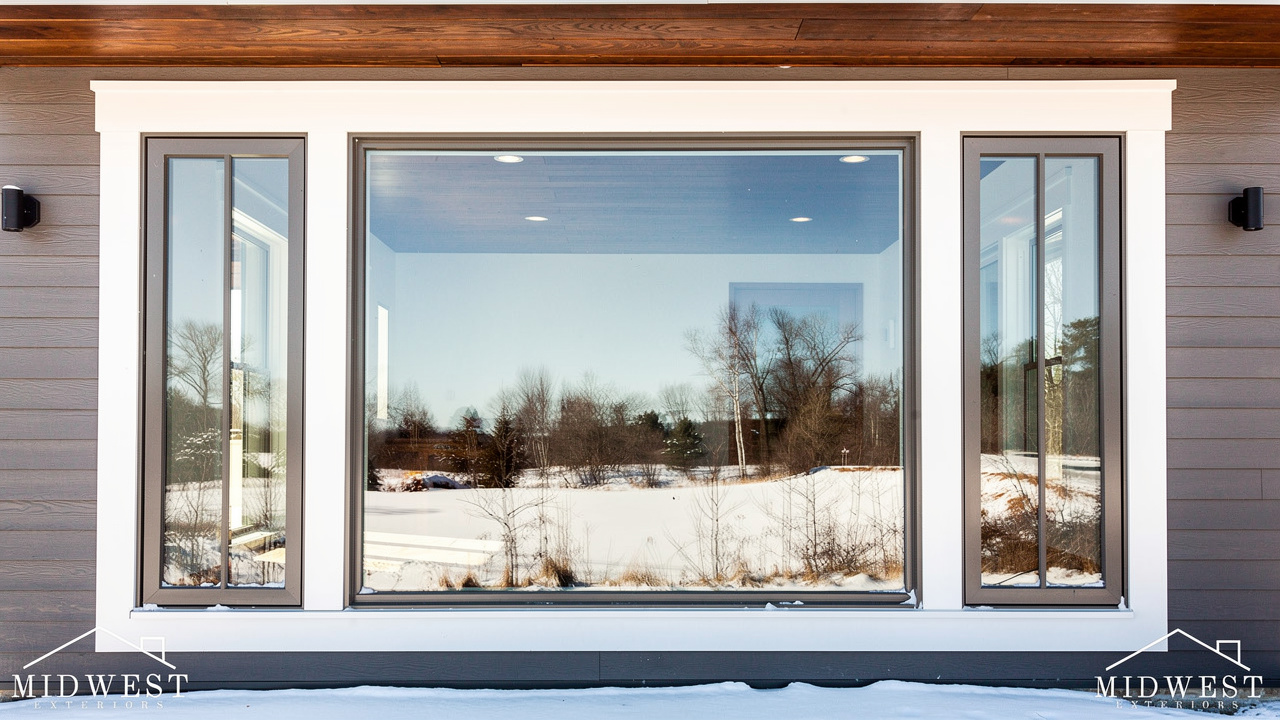 Contemporary home with large picture window flanked by casement windows